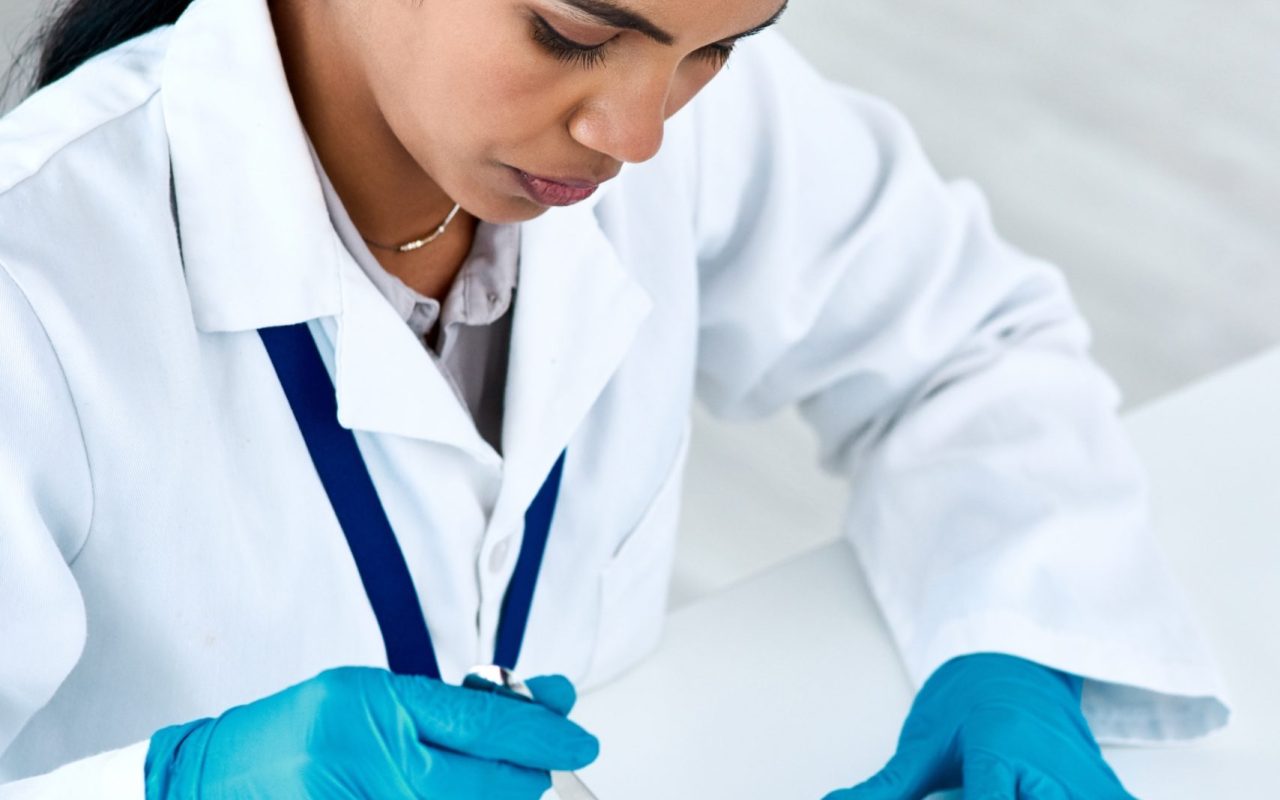Hospital, pharmacist or woman for counting tablets, pills and supplements on stainless tray. Pharmacy, female employee and medicine for sorting, preparation and quantity check of prescription.